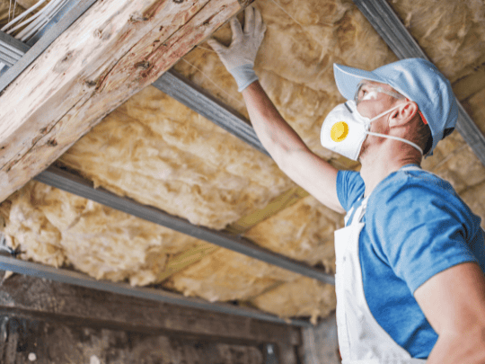 a person inspecting insulation