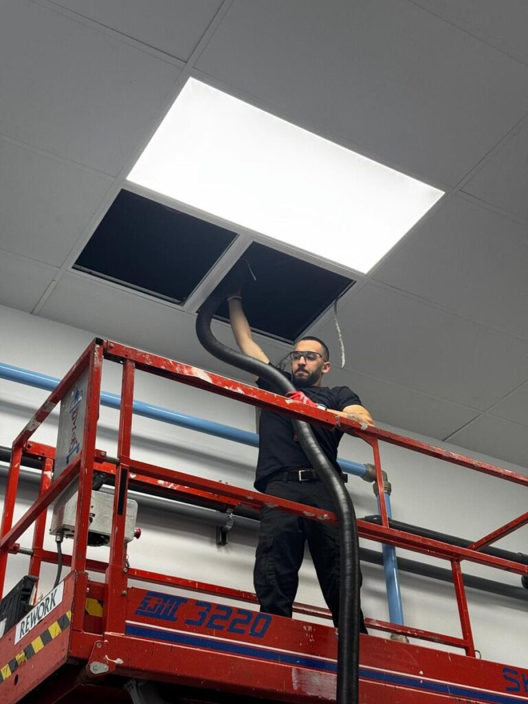 Air Duct Cleaning for Manufacturing - A man cleaning dryer in manufacture
