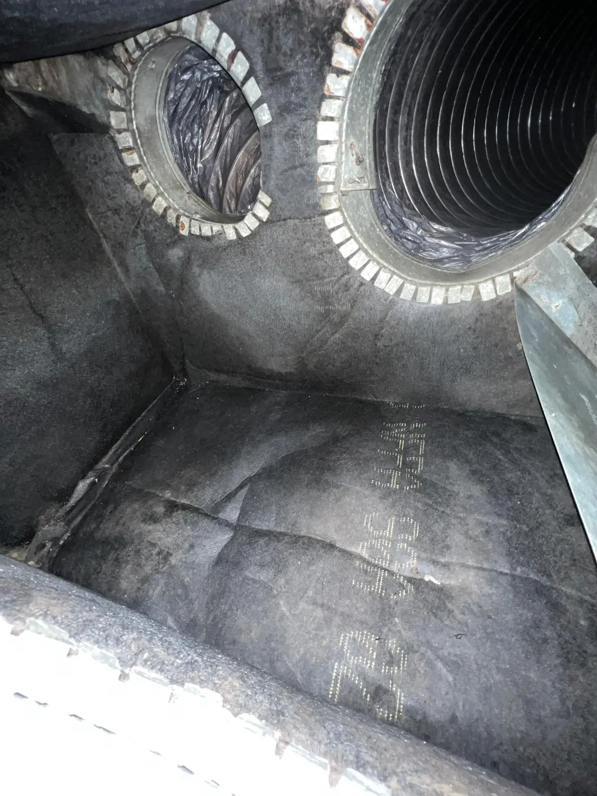 An interior view of the same plenum box after professional cleaning, showing the metal surfaces and duct openings free of debris, mold, and dust, with a noticeably reflective and sanitized appearance