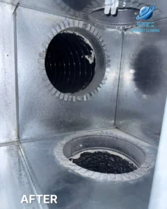 The clean interior of a metal air distribution box with two duct ports visible in a residential system.